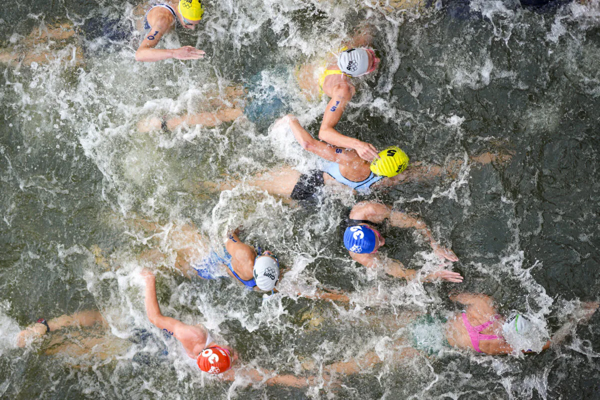 Australia's Natalie Van Coevorden (15), Belgium's Claire Michel (5), and Ekaterina Shabalina, of Kazakhstan (32) compete in the swim leg of the women's individual triathlon competition at the 2024 Summer Olympics, in Paris, France, on July 31, 2024. (David Goldman/AP Photo)