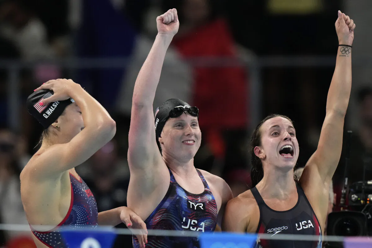 (L–R) Gretchen Walsh, Lilly King, and Regan Smith celebrate winning the gold medal in the women's 4x100-meter medley relay final at the Summer Olympics in Nanterre, France, on Aug. 4, 2024. (Natacha Pisarenko/AP Photo)