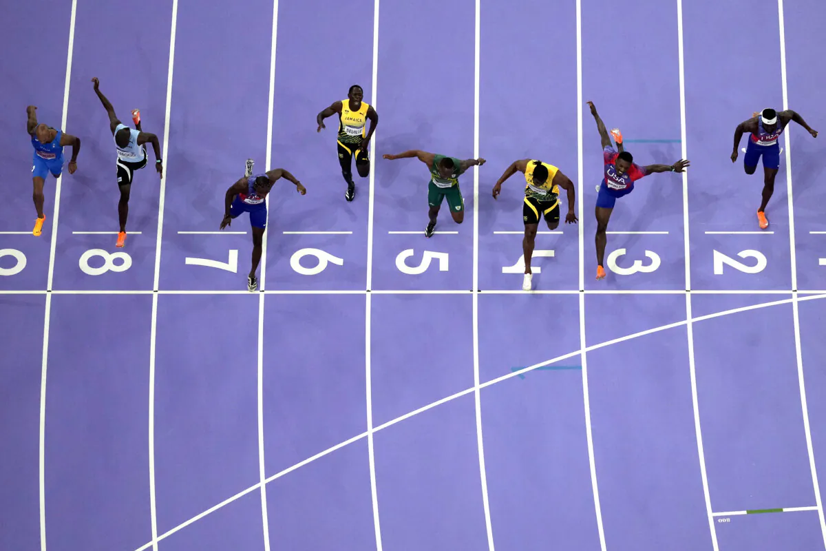Noah Lyles of the United States, in lane seven, wins the men's 100-meter final at the 2024 Summer Olympics in Saint-Denis, France, on Aug. 4, 2024. (David J. Phillip/AP Photo)
