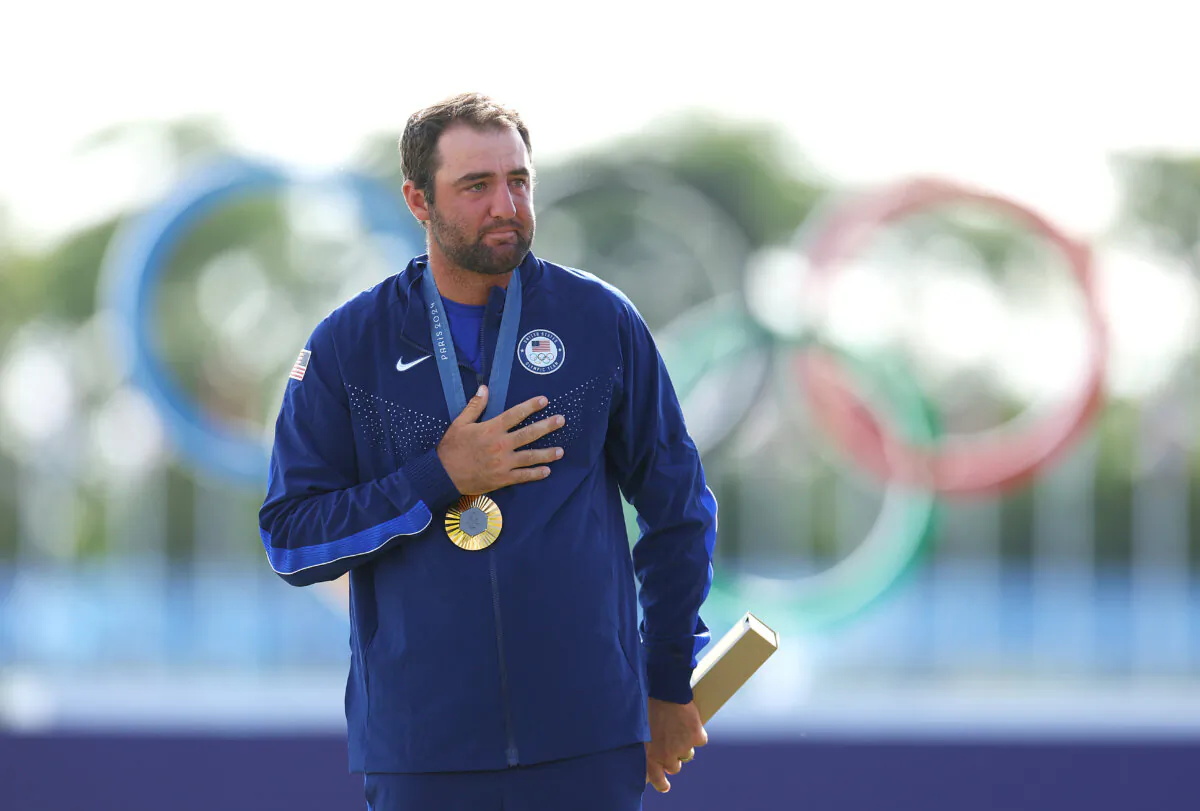 Gold medalist, Scottie Scheffler of Team United States reacts on the podium during the men's individual stroke play medal ceremony on day nine of the Olympic Games Paris 2024 at Le Golf National in Paris, France, on Aug. 4, 2024. (Andrew Redington/Getty Images)