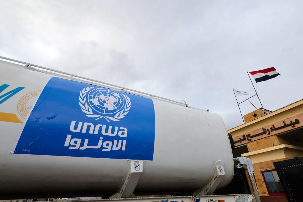 A truck, marked with the U.N. Relief and Works Agency (UNRWA) logo, crosses into Egypt from Gaza, at the Rafah border crossing between Egypt and the Gaza Strip, during a temporary truce between Hamas and Israel, in Rafah, Egypt, on Nov. 27, 2023. (Amr Abdallah Dalsh/Reuters)