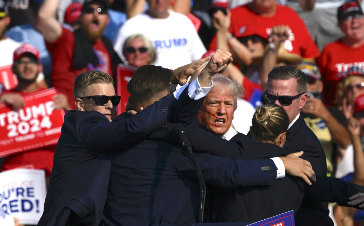 Republican presidential candidate, former President Donald Trump, is whisked away by Secret Service after shots rang out at a campaign rally at Butler Farm Show Inc. in Butler, Pa., on July 13, 2024. (Jeff Swensen/Getty Images)