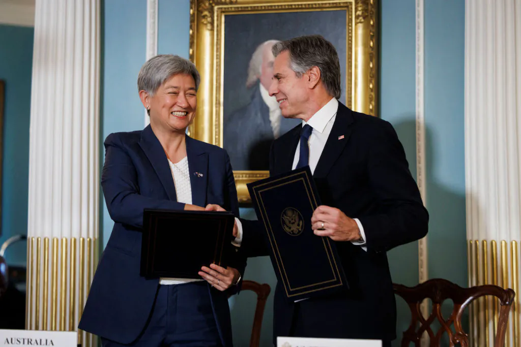 U.S. Secretary of State Antony Blinken shakes hands with Australian Foreign Minister Penny Wong during a signing ceremony of the memorandum of understanding on Countering Foreign State Information Manipulation and a joint communiqué on the US-Australia Landsat Next 2030 International Partnership Initiative, at the State Department in Washington, D.C., on Aug. 5, 2024. (Ting Shen/AFP via Getty Images)