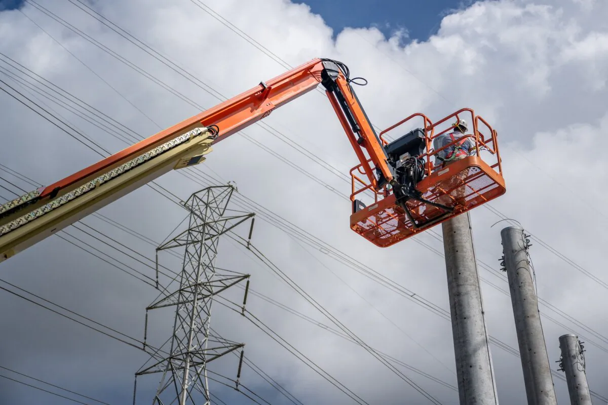 Service technicians work to install transmission towers at a power plant in Houston, Texas, on June 10, 2022. (Brandon Bell/Getty Images)