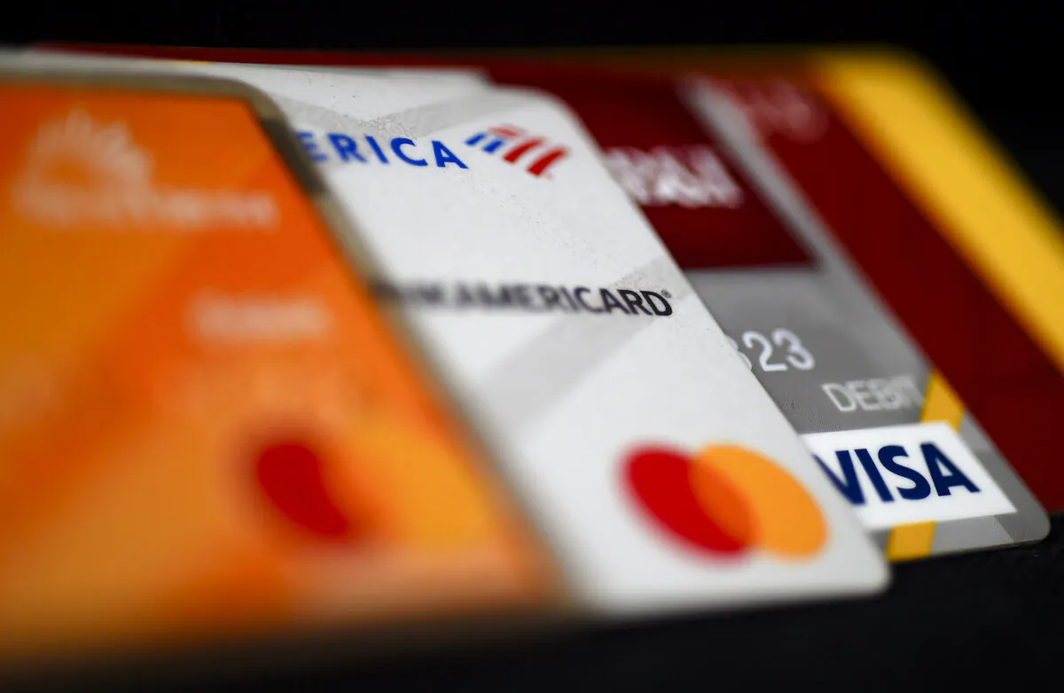 This illustration picture shows debit and credit cards arranged on a desk in Arlington, Va. on April 6, 2020. (Olivier Douliery/AFP via Getty Images)