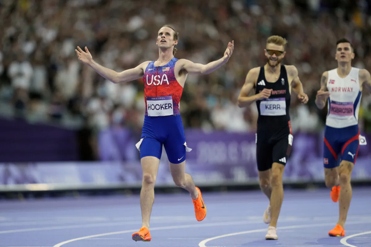 Cole Hocker of the United States crosses the finish line ahead of Britain's Josh Kerr and fourth-place finisher Jakob Ingebrigtsen of Norway to win the men's 1500-meter final at the Summer Olympics in Saint-Denis, France, on Aug. 6, 2024. (Ashley Landis/AP Photo)