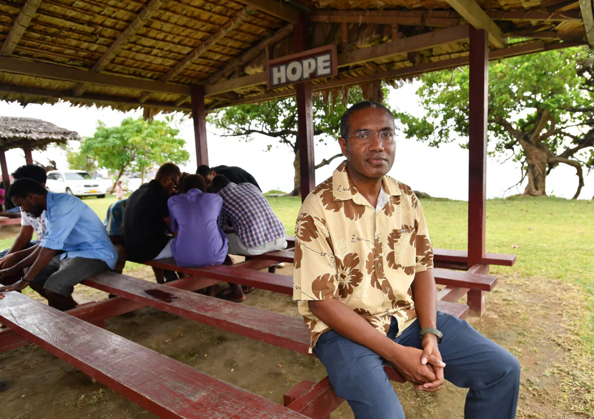 Solomon Island's United Party leader Peter Kenilorea Junior (right) is seen posing for a photograph at the South Sea Evangelical Church in Honiara, the Solomon Islands, on June 2, 2019. (AAP Image/Darren England)