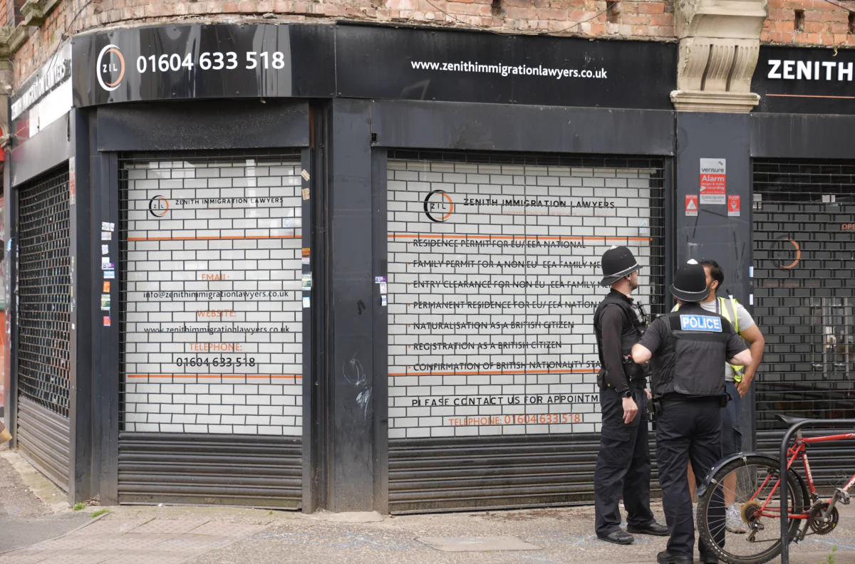 Police officers outside Zenith Immigration Lawyers in Northampton ahead of an anti-immigration protest on Aug. 7 2024 (Joe Giddens/PA Wire)