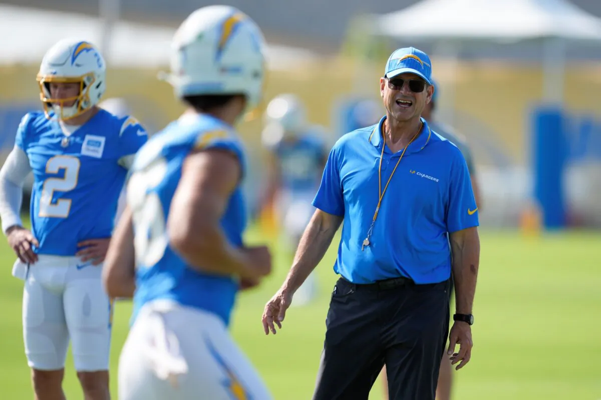 Former Michigan football Coach Jim Harbaugh (R) at work in his new job with the Los Angeles Chargers during training camp in El Segundo, Calif., on July 24, 2024. (Marcio Jose Sanchez/AP Photo)