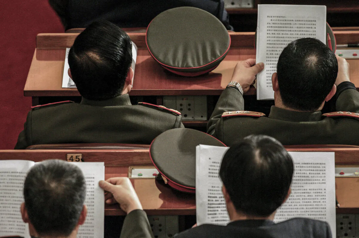Military delegates follow a speech by National People's Congress (NPC) Chairman Wu Bangguo, at the Great Hall of the People in Beijing on March 11, 2007. (Frederic J. Brown/AFP via Getty Images)