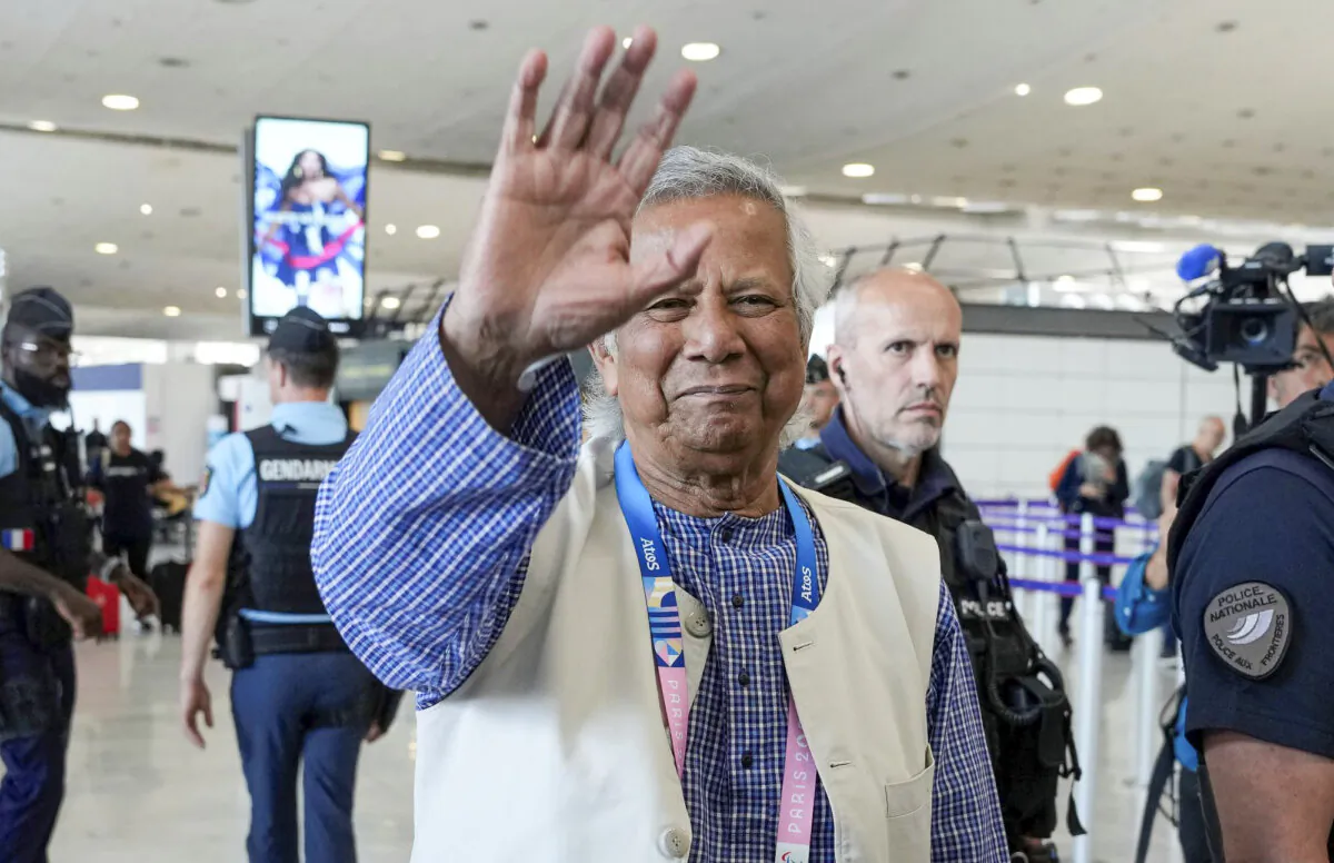 Nobel laureate Muhammad Yunus waves goodbye to the media at Charles de Gaulle's airport in Roissy, north of Paris, on Aug. 7, 2024. (Michel Euler/AP Photo)