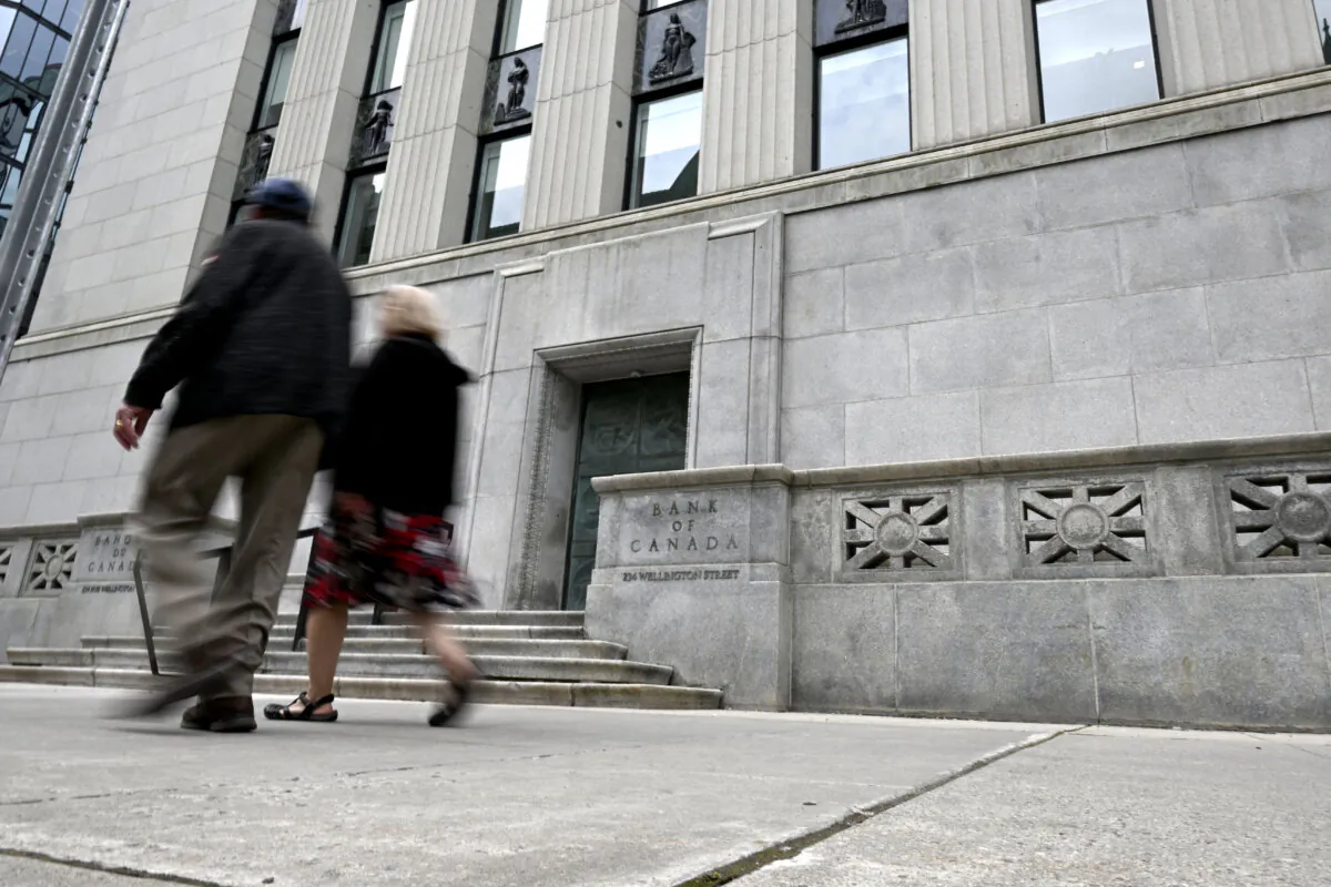 People pass the Bank of Canada in Ottawa on July 24, 2024. (The Canadian Press/Justin Tang)