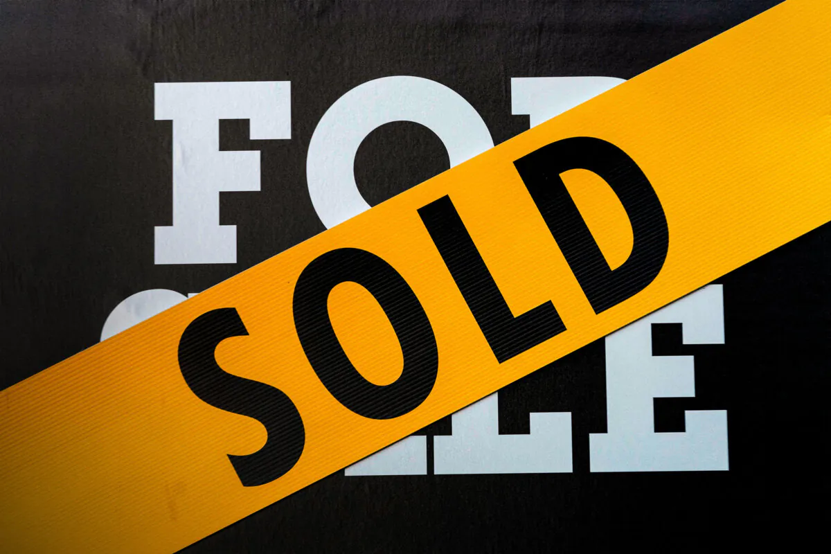 A “Sold” banner is displayed over a “For Sale” sign in front of a house in Washington on March 14, 2022. (Stefani Reynolds/AFP via Getty Images)