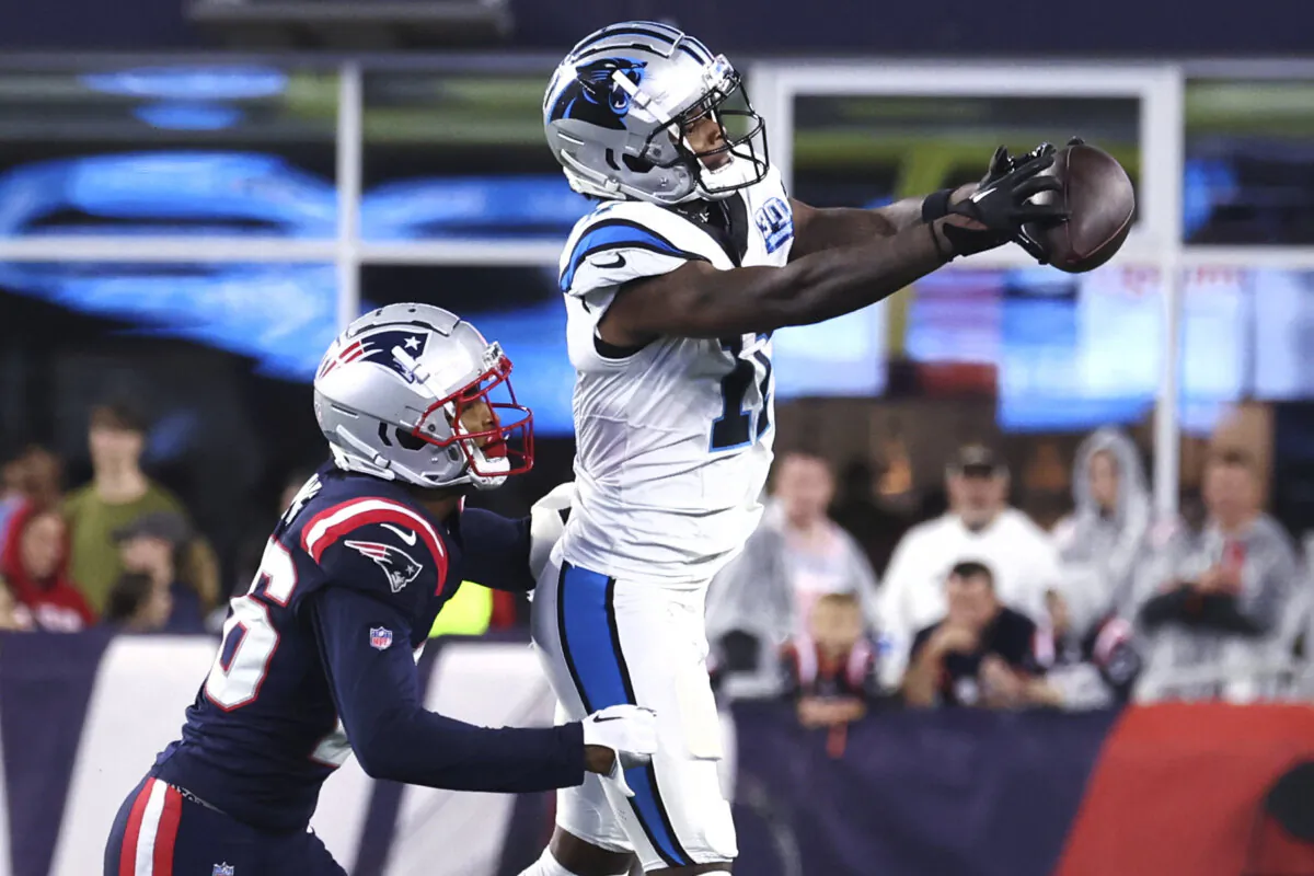 Carolina Panthers wide receiver Ihmir Smith-Marsette (11) grabs a pass against New England Patriots cornerback Shaun Wade, left, during the first half of a preseason NFL football game, Thursday, Aug. 8, 2024, in Foxborough, Mass. (AP Photo/Mark Stockwell)