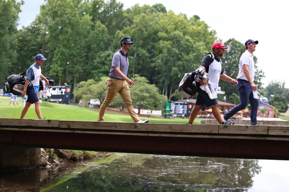 Beau Hossler of the United States walks across a bridge during the first round of the Wyndham Championship in Greensboro, N.C., on Aug. 9, 2024. (David Jensen/Getty Images)