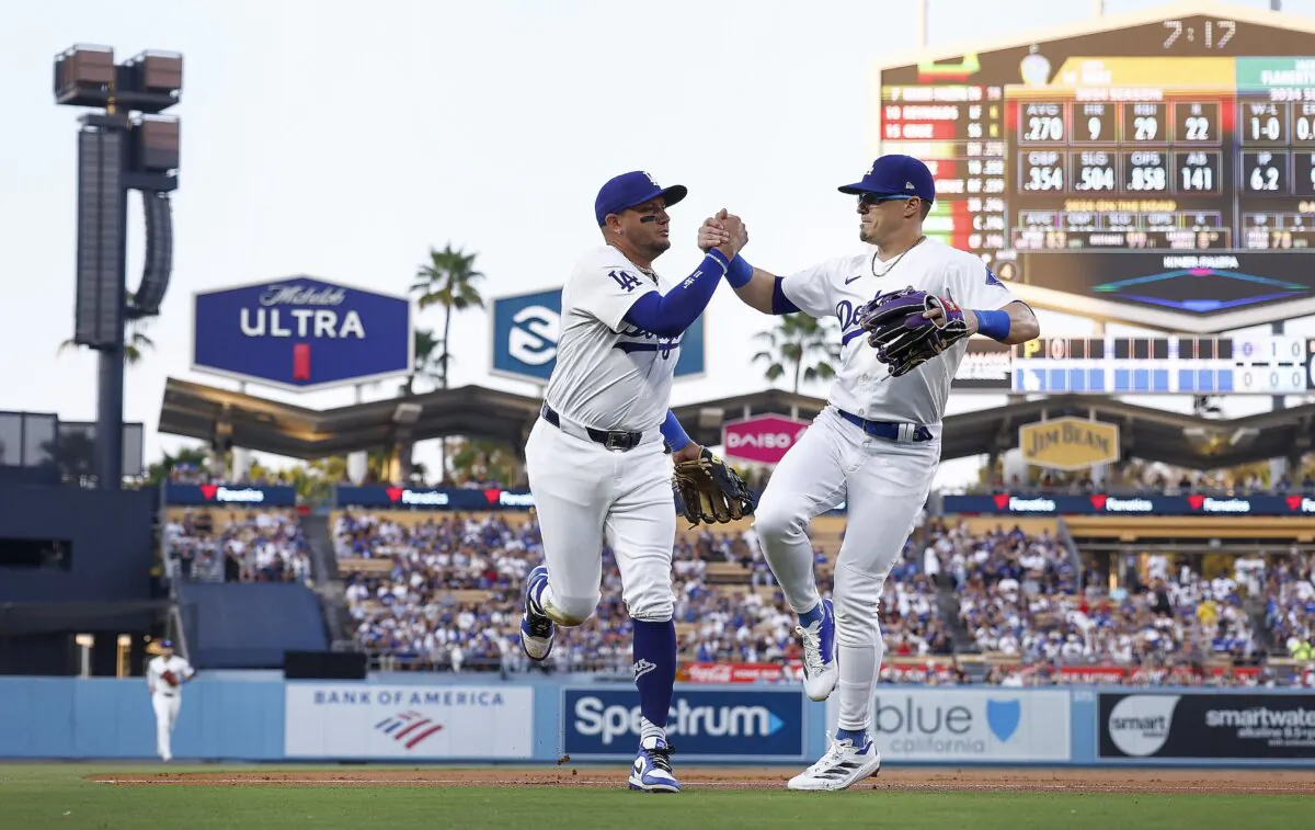 Miguel Rojas (11) and Enrique Hernández (8) of the Los Angeles Dodgers after the third out against the Pittsburgh Pirates in the first inning at Dodger Stadium in Los Angeles on Aug. 9, 2024. (Ronald Martinez/Getty Images)