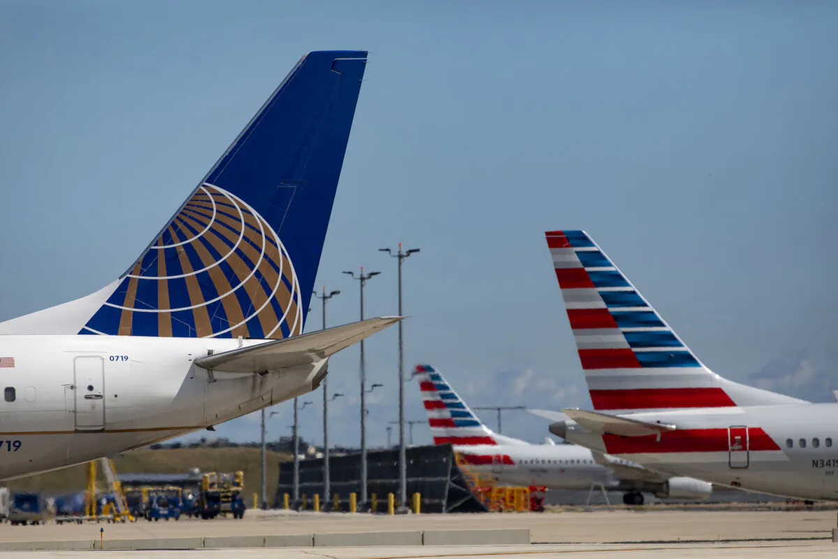 United Airlines and American Airlines jets on Sept. 9, 2021, at O'Hare International Airport. When it comes to delays, American Airlines doesn't give reasons for them in their app or on their website, while United typically explains the delay on their flight status page.(Brian Cassella/Chicago Tribune/TNS)