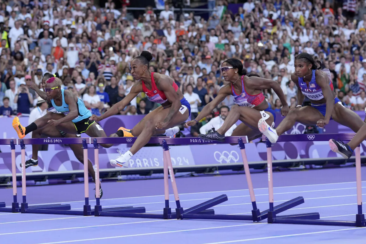 Competitors race in the women's 100-meter hurdles final at the 2024 Summer Olympics in Saint-Denis, France, on Aug. 10, 2024. (Bernat Armangue/AP Photo)