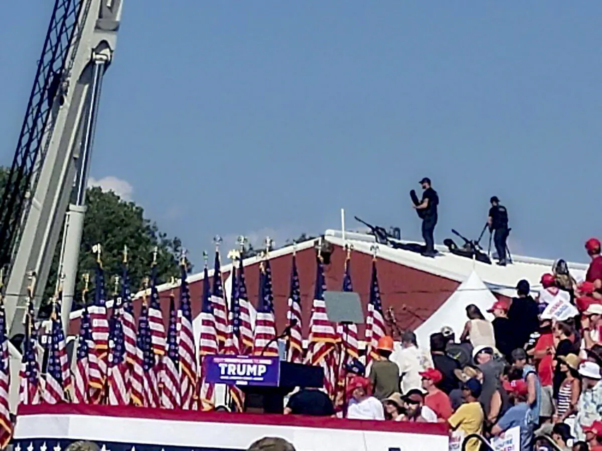 Snipers stand on a roof at former President Donald Trump's rally in Butler, Pa., on July 13. (Glen Van Tryfle/TMX via Reuters)