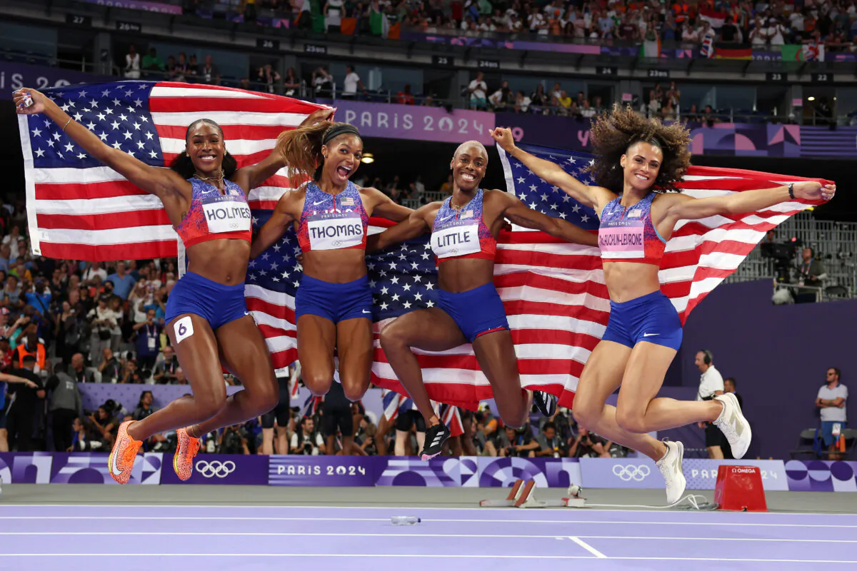 Shamier Little, Sydney McLaughlin-Levrone, Gabrielle Thomas, and Alexis Holmes of Team United States celebrate winning the gold medal in the women's 4x400-meter relay final on day fifteen of the Olympic Games Paris 2024 at Stade de France in Paris, France, on Aug. 10, 2024. (Patrick Smith/Getty Images)