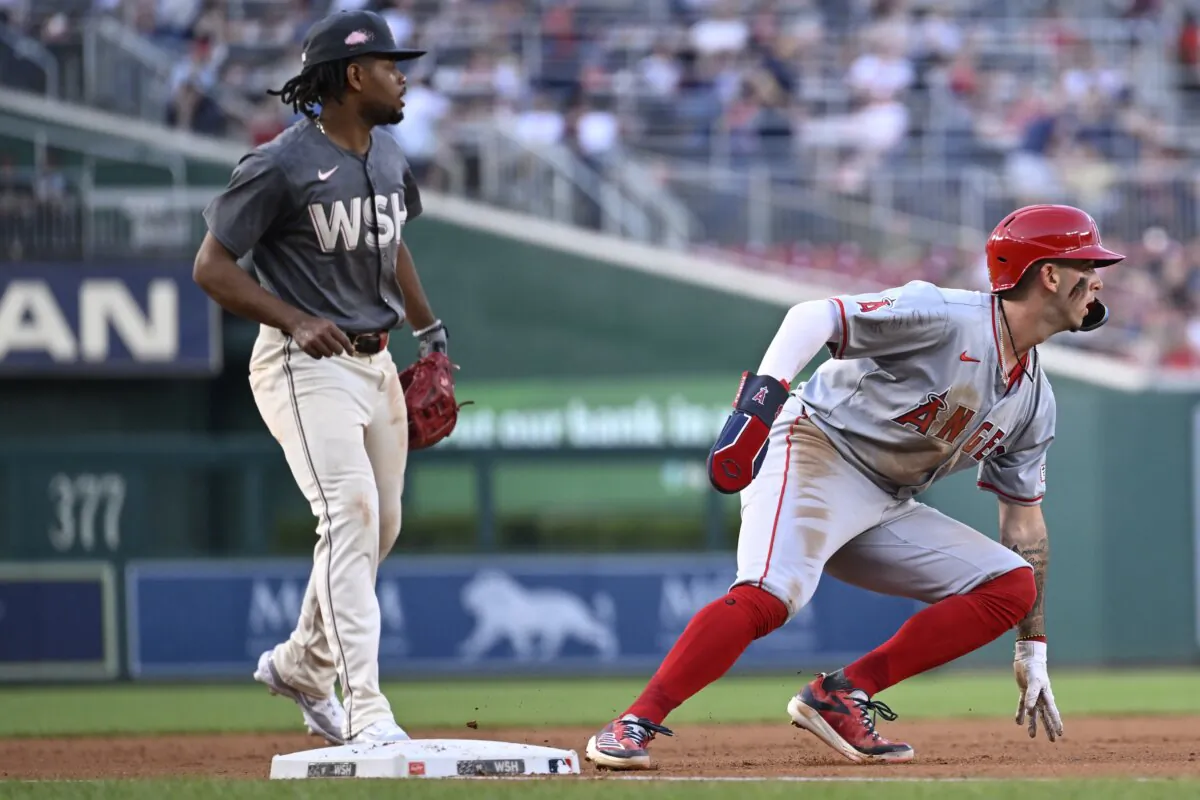 Washington Nationals third baseman Jose Tena (L) watches as Los Angeles Angels' Zach Neto turns back to second base resulting in a double play, to end the third inning of a baseball game in Washington on Aug. 10, 2024. (John McDonnell/AP Photo)