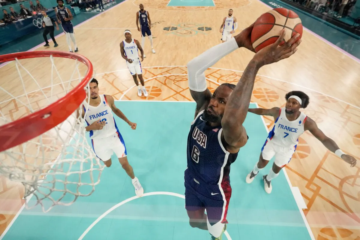 LeBron James of Team USA dunks during the men's gold-medal basketball game against France at the Olympics in Paris on Aug. 10, 2024. (Mark Terrill/POOL/AFP via Getty Images)