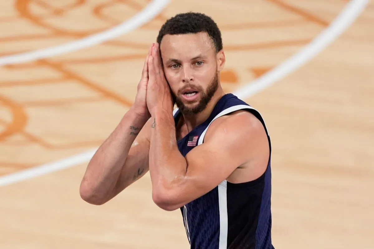 Stephen Curry of Team USA, with his trademark "night-night" gesture, lets everyone know the Olympic men's basketball gold medal has been decided in Paris on Aug. 10, 2024. (Michael Conroy/AP Photo)
