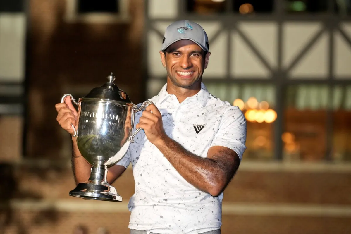 Aaron Rai poses with the winner's trophy after capturing the Wyndham Championship in Greensboro, N.C., on Aug. 11, 2024. (Chuck Burton/AP Photo)