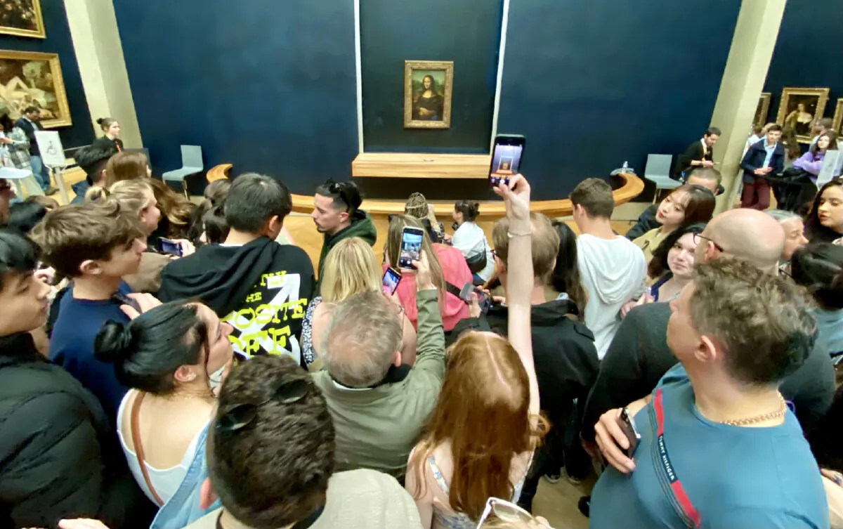 Visitors in a crowd at the Louvre Museum in Paris, France, attempt to photograph the "Mona Lisa." (Photo courtesy of Andrew Sutherland/Dreamstime)