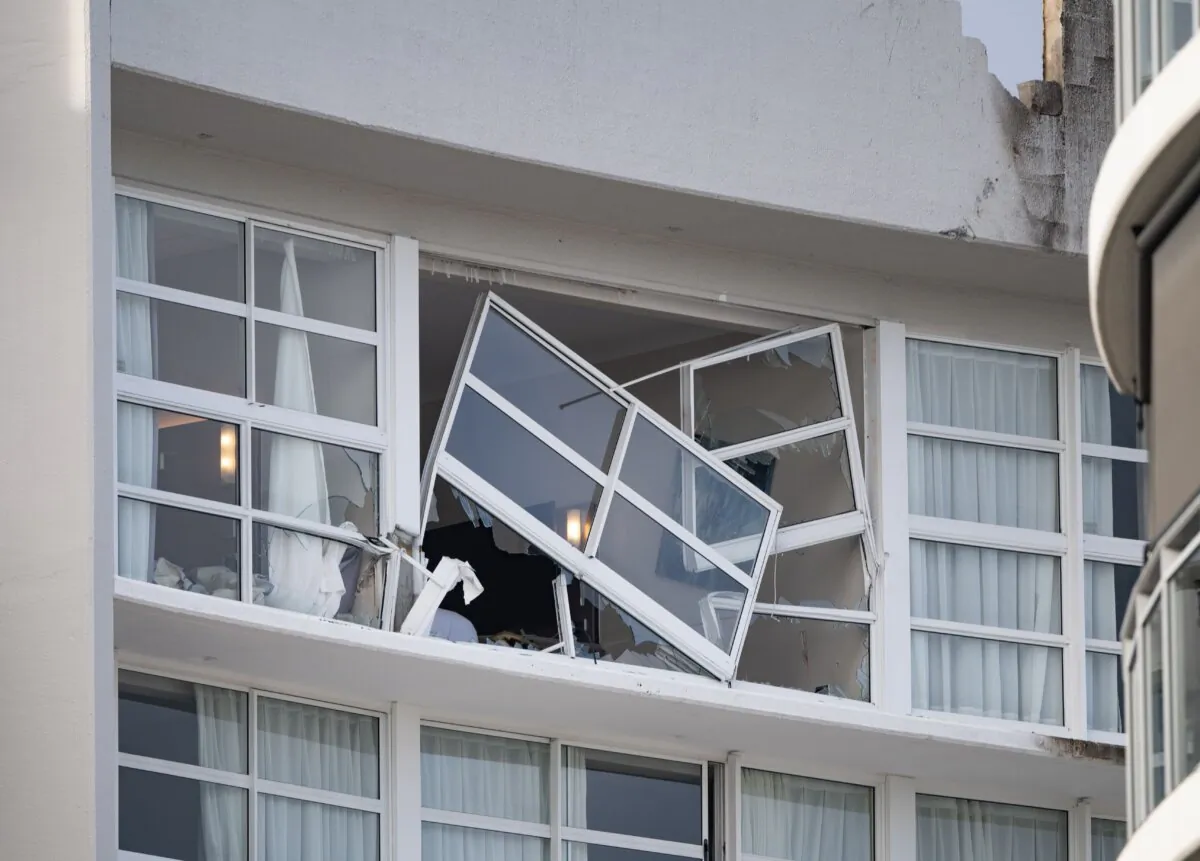 A broken window and damaged rooftop is seen at the Double Tree by Hilton Hotel after a helicopter crashed into its roof, in Cairns, Australia, on Aug.12, 2024. (AAP Image/Brian Cassey)