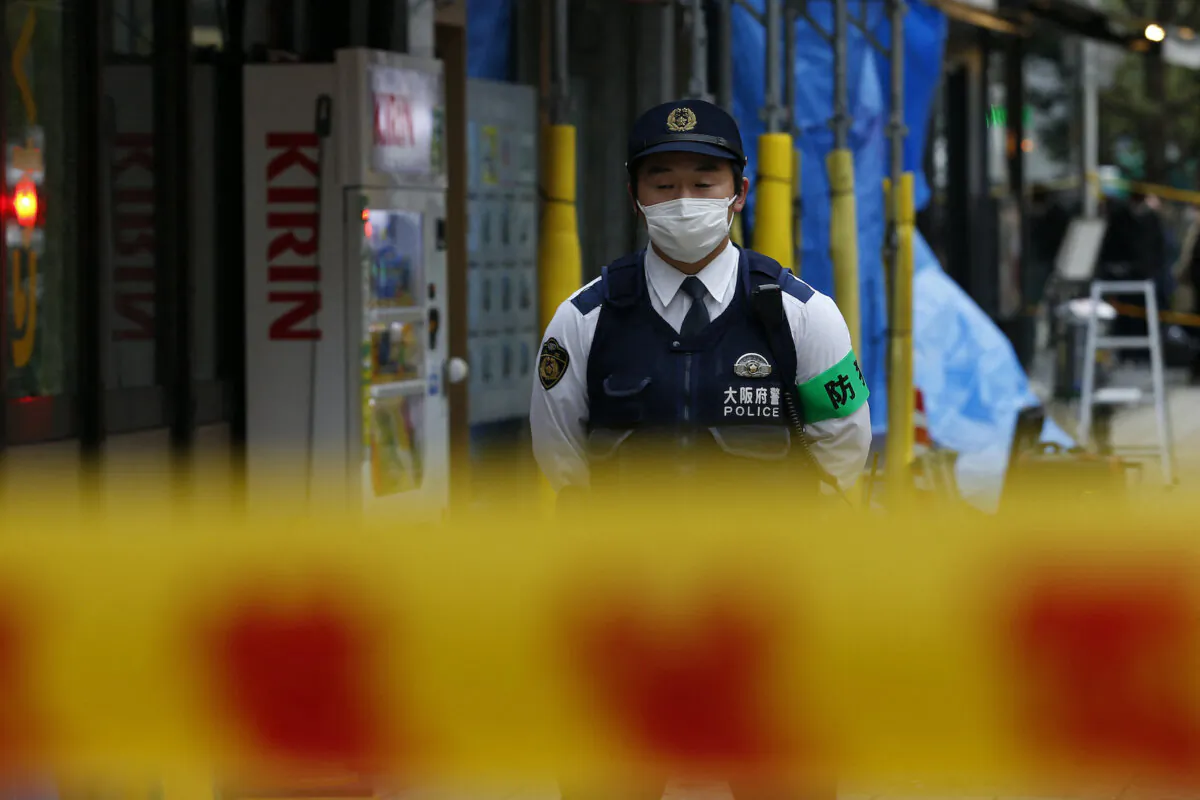 A police officer stands guard outside an office building in Osaka on Dec. 17, 2021. (Buddhika Weerasinghe/AFP via Getty Images)