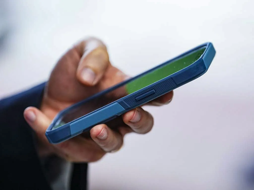 A person uses a cell phone in a file photo. (The Canadian Press/Sean Kilpatrick)