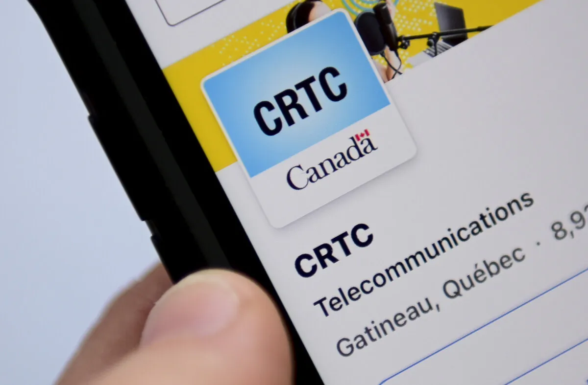 A person navigates to the online social media pages of the CRTC in a file photo. (The Canadian Press/Sean Kilpatrick)