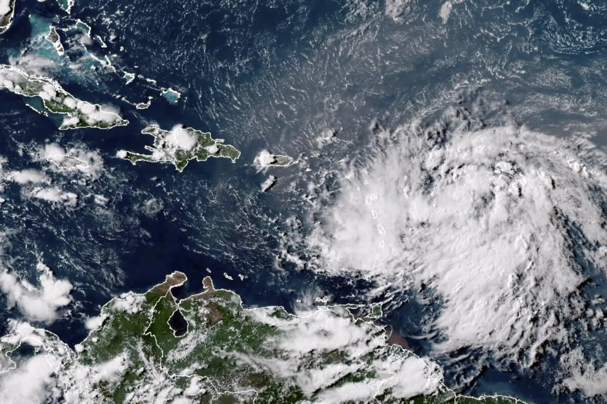 A satellite image shows Tropical Storm Ernesto over the Atlantic Ocean and moving west-northwest toward the Lesser Antilles at 4:30 p.m. ET on Aug. 12, 2024. (NOAA via AP)