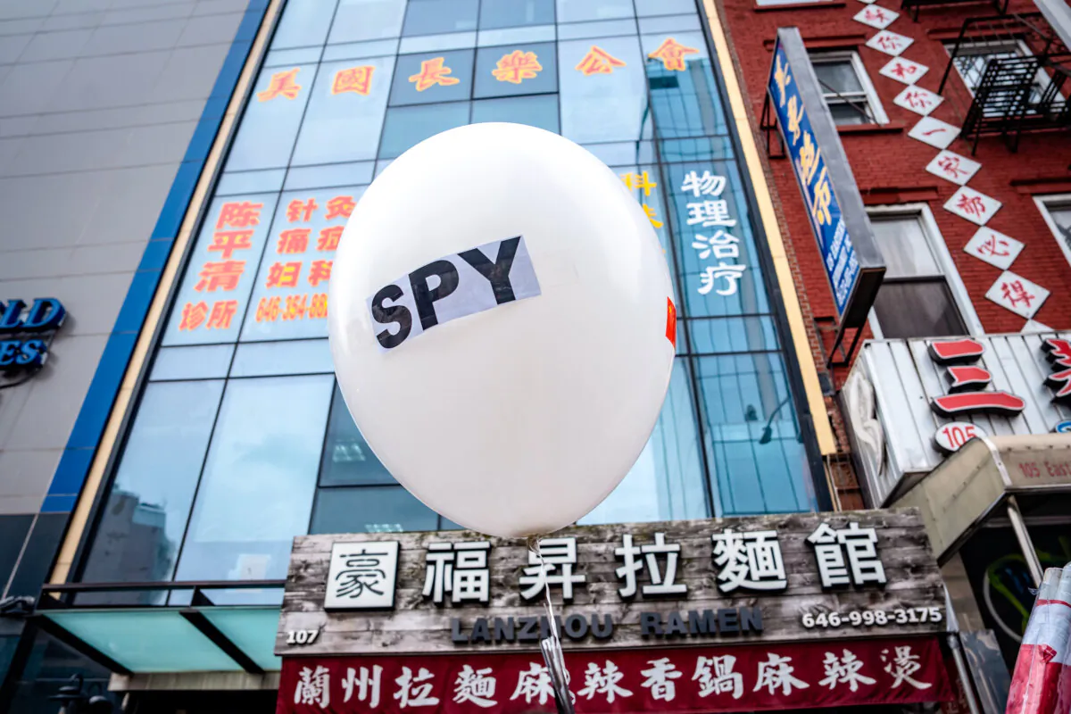 A balloon is held at a press conference in front of a building holding a now-closed Chinese police station, in New York City on Feb. 25, 2023. (Samira Bouaou/The Epoch Times)