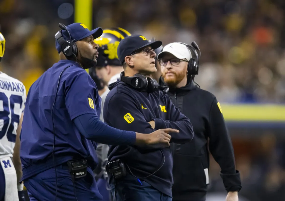 Then-Michigan offensive line coach Sherrone Moore (L), Coach Jim Harbaugh (C), and special-teams coordinator Jay Harbaugh during the Big Ten Conference championship game against Iowa in Indianapolis on Dec 4, 2021. (Mark J. Rebilas/USA TODAY via Field Level Media)
