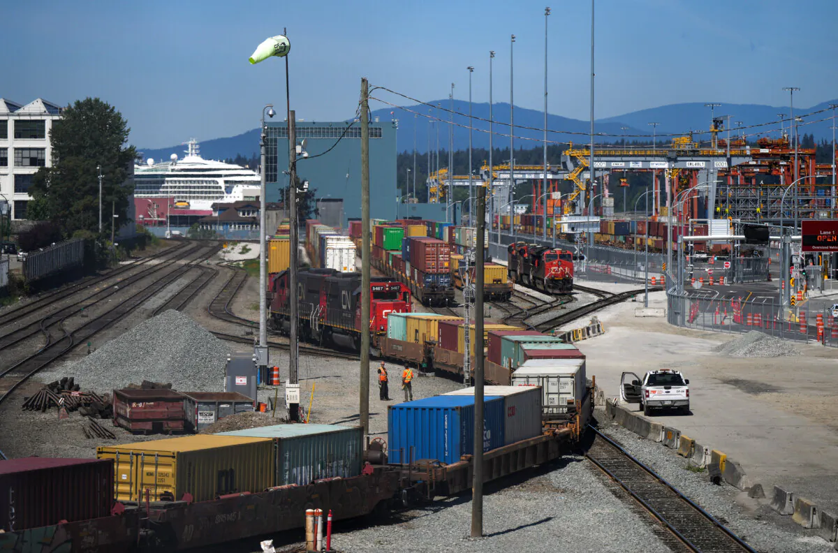 A CN train moves cargo containers at the Centerm container port in Vancouver on July 14, 2023. (The Canadian Press/Darryl Dyck) 