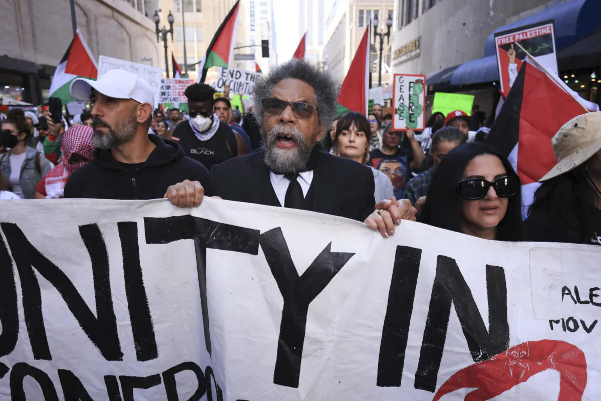 Political activist Cornel West (center) holds a banner during a pro-Palestine rally in downtown Los Angeles on Oct. 28, 2023. (David Swanson/AFP via Getty Images)