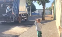 The Little Boy Waves at the Garbage Collectors
