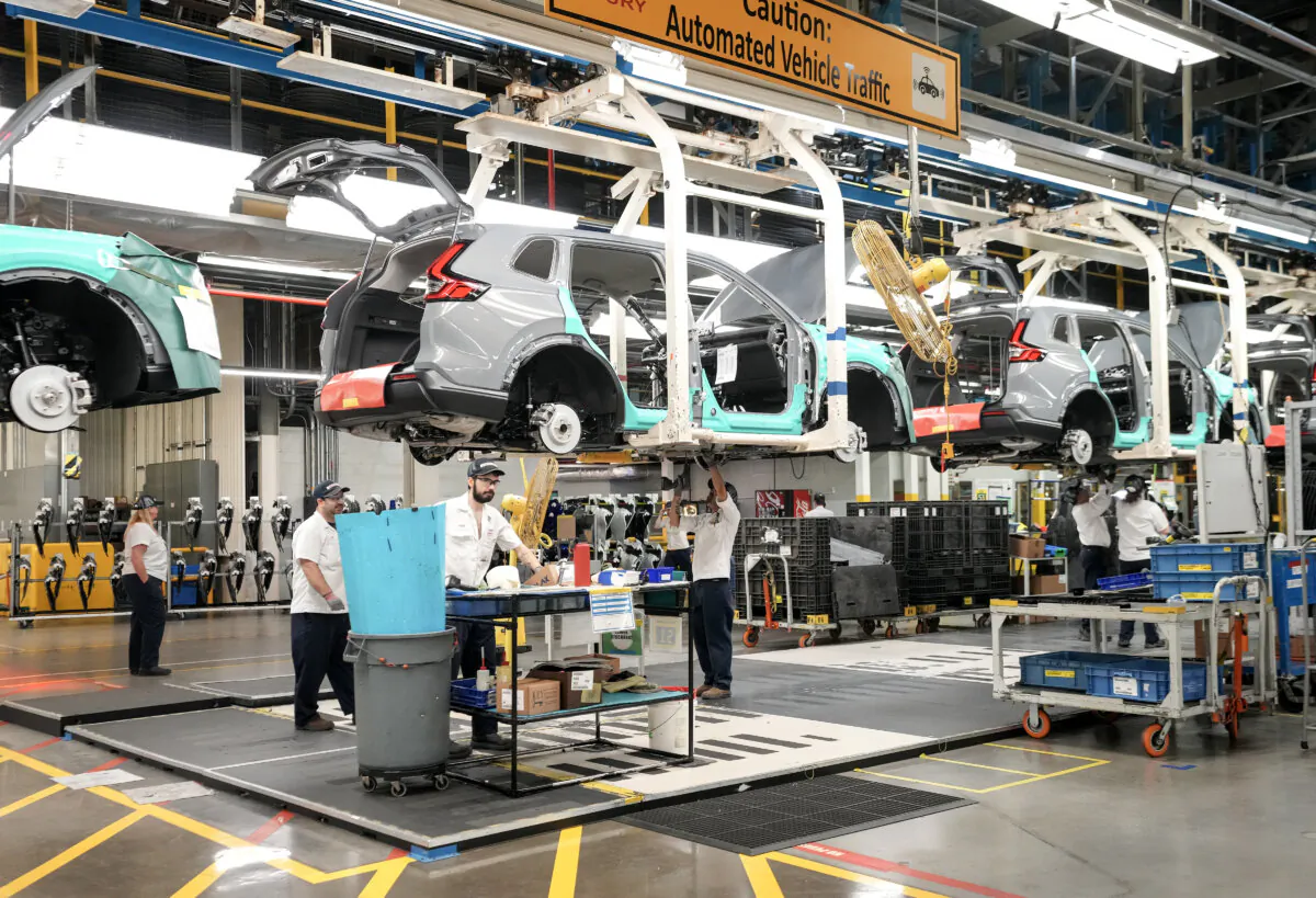 Honda employees work along the vehicle assembly line in Alliston, Ont., on April 25, 2024. (The Canadian Press/Nathan Denette)