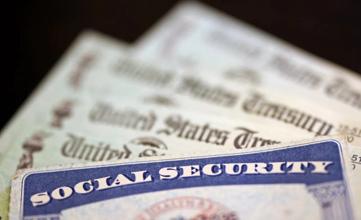 A Social Security card sits alongside checks from the U.S. Treasury in Washington on Oct. 14, 2021. (Kevin Dietsch/Getty Images)