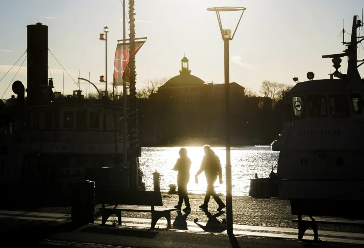 People stroll along the Standvagen quayside in Stockholm, Sweden, in a file photograph. (TT News Agency/Fredrik Sandberg via Reuters)