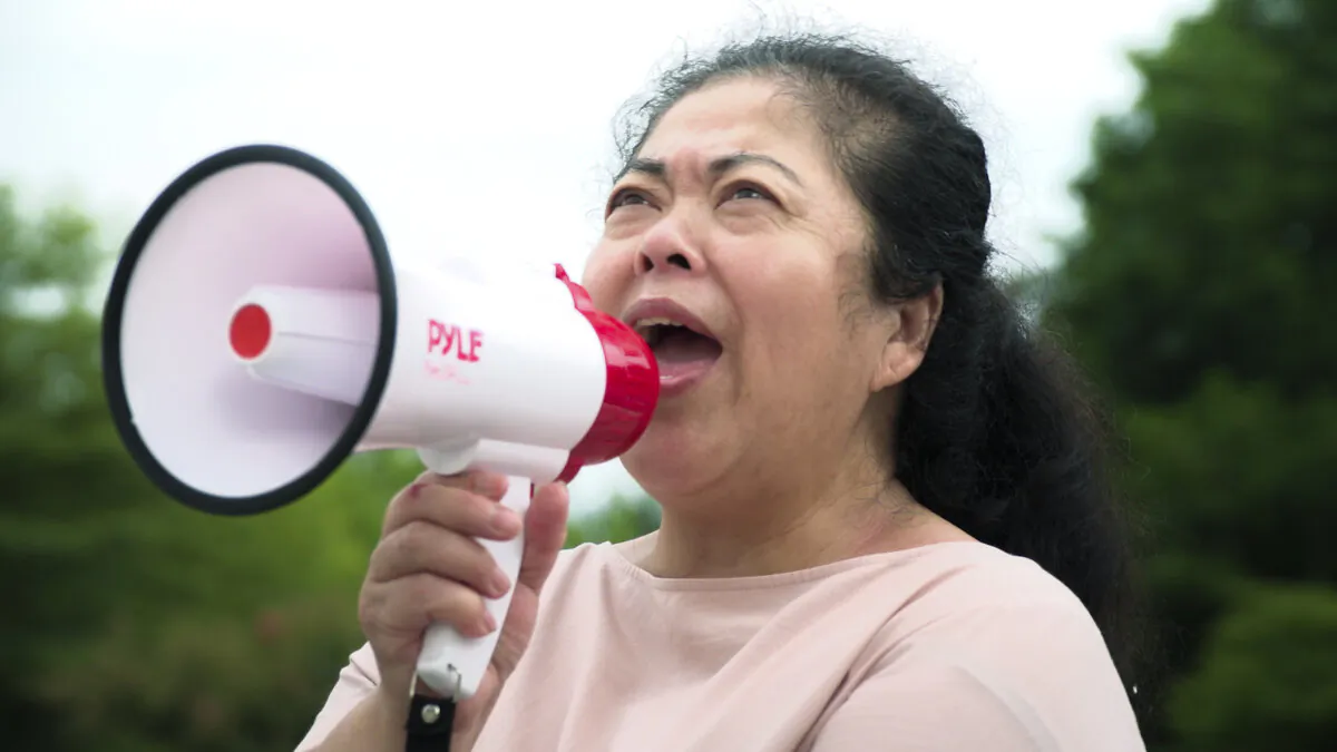 A homeless asylum seeker protests outside the Chinese embassy for redress, in the documentary "The Dissidents." (C35 Films Production)