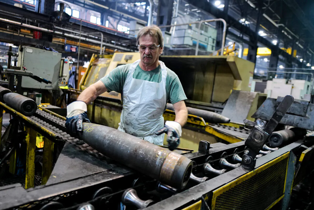A worker handles 155 mm calibre shells after the manufacturing process at the Scranton Army Ammunition Plant in Scranton, Pa., on April 16, 2024. (Charly Triballeau/AFP via Getty Images)