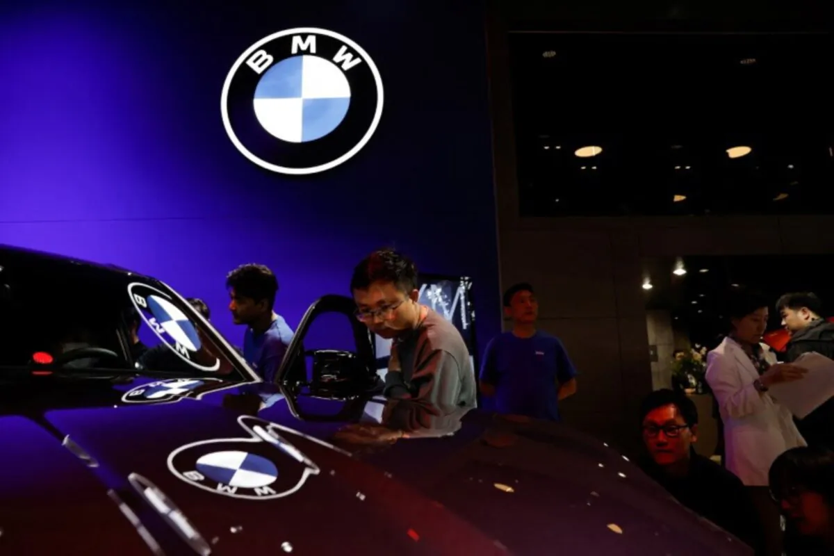 Visitors view a vehicle  at the BMW booth at the Beijing International Automotive Exhibition  on April 25, 2024. (Tingshu Wang/Reuters)
