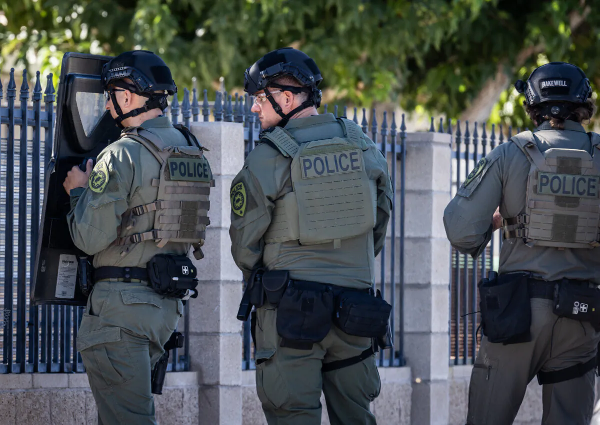 Police officers raid an illegal cannabis site in Lancaster, Calif., on Aug. 14, 2024. (John Fredricks/The Epoch Times)