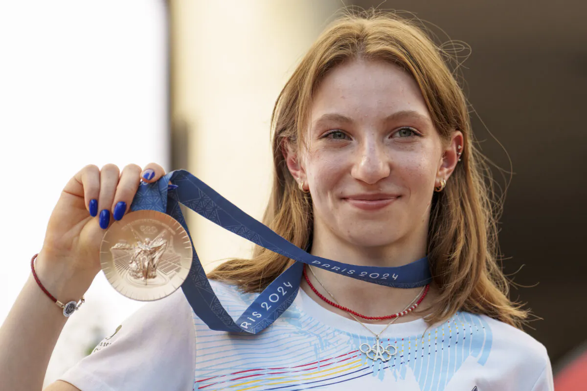 Romanian gymnast Ana Barbosu poses with the bronze medal for her women's artistic gymnastics individual floor performance at the Paris 2024 Olympics, after receiving it during a ceremony at the Romanian Olympic and Sports Committee, in Bucharest, Romania, on Aug. 16, 2024. (Vadim Ghirda/AP Photo)