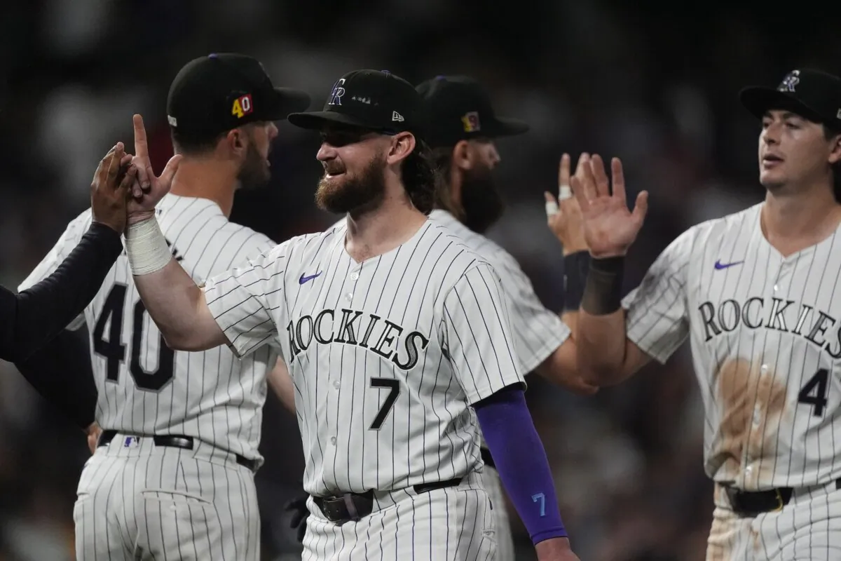 Colorado Rockies second baseman Brendan Rodgers (7) is congratulated after a baseball game against the San Diego Padres in Denver on Aug. 16, 2024. (David Zalubowski/AP Photo)