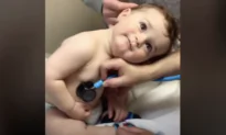 Baby Boy Lays Head on Nurse