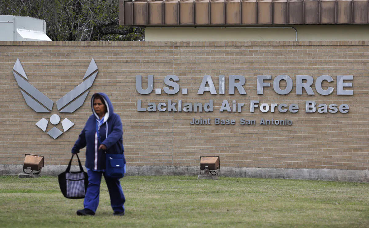 A pedestrian passes the main gate at Lackland Air Force Base in San Antonio on Feb. 5, 2020. (Eric Gay/AP Photo)